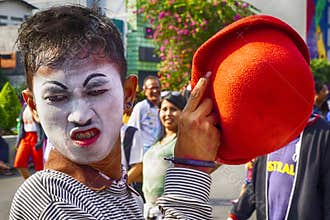 Street clown is in action on his stage, the street.