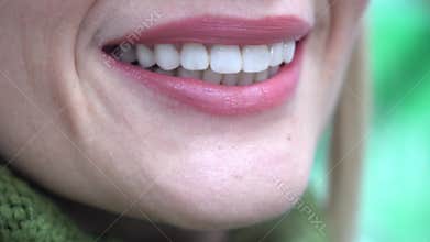 Portrait of a smiling woman looking at camera after visiting the dentist