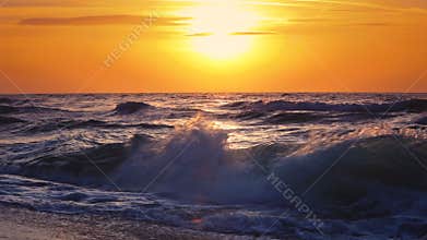 Sunrise over the sea waves
