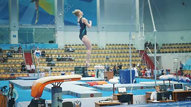 KAZAN, RUSSIA - APRIL 19, 2018: All-Russian gymnastics championship -Flexible young woman whirling in a vault