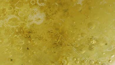 Abstract close-up on the surface of boiling water and oil
