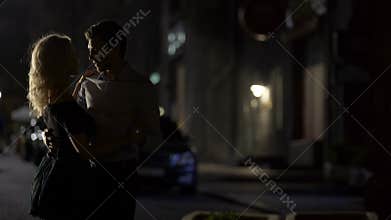 Silhouettes of male and female dancing and enjoying romantic date, evening time