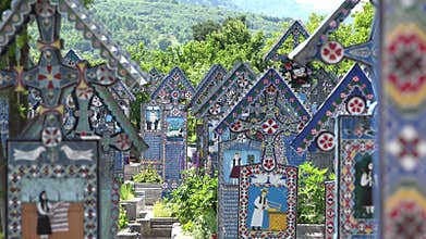 Colored crosses in Merry Cemetery, spring green nature, sapanta, romania