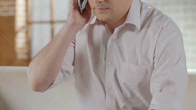 Guy talking over mobile phone and finishing call, making appointment, healthcare