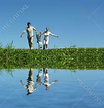 Family on herb under blue sky