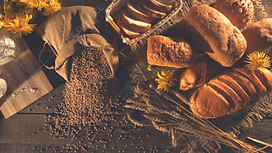 Still life with bread, wheat, flour and flowers.