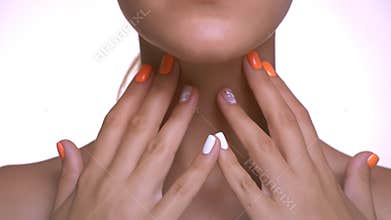 Tender touch on smooth cheeks and neck with both hands of caucasian girl, beauty and healthy appearance