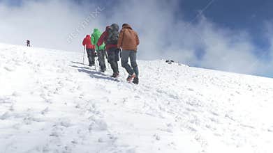 Climbers go up to the top on a snowy slope. On a nice sunny day. Mount Elbrus, Caucasus slow motion