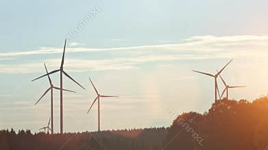 Wind turbine and agricultural fields on a summer day