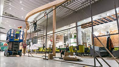 Workers group assemble cafe facade in center hall timelapse