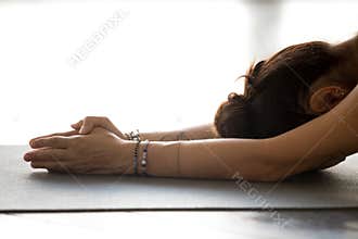 Young woman practicing yoga, doing meditation exercise