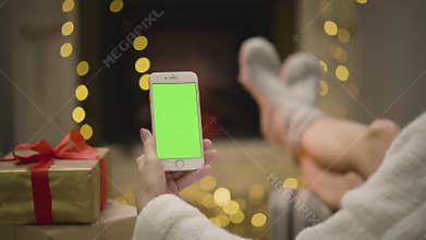 Fireplace flame and woman`s feet in motion.