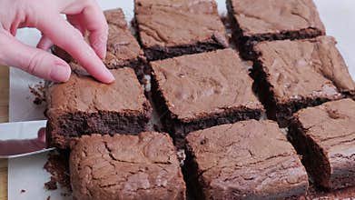Taking out slice of chocolate cake - brownie.
