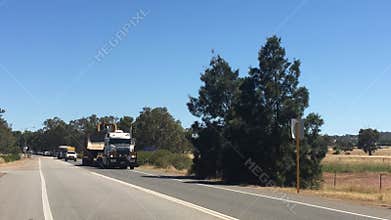 Oversize load mobile convoy of large mining machinery to mine work