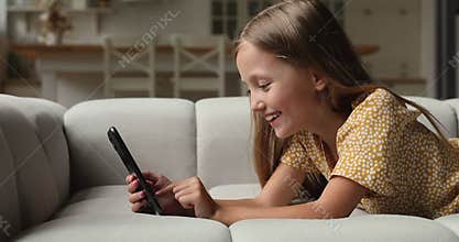 Happy adorable little kid girl holding video call talk.