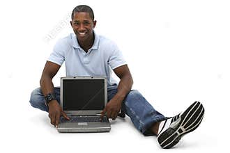 Attractive Young Man Sitting On Floor with Laptop Computer