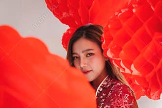 Asian beautiful woman wearing traditional cheongsam qipao dress take photography with group of red chinese lanterns