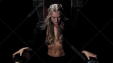 Beautiful blonde woman from medieval age is sitting on the throne, 4k