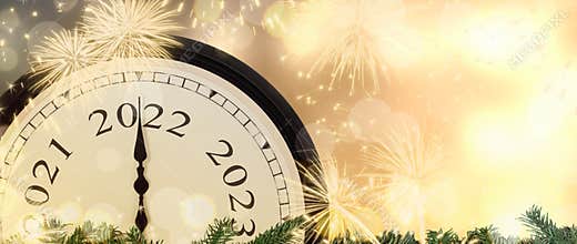 New Year 2022 clock and fireworks background.