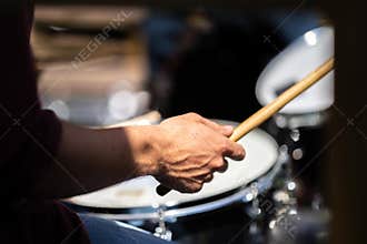 close up man and women drummer playing on a drum kit, in a band, at a gig in the sun, in Australia
