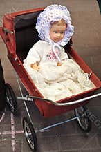 Antique doll in cradle