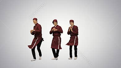Three smiling chef cooks in red uniform synch dancing against green background and pointing at camera at the end on