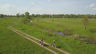 Family cycling on bikes outdoors aerial view from above, happy active mother with child have fun, family sport