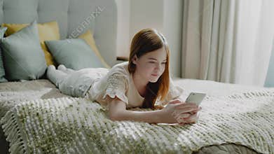 Lovely Young Girl Surf Internet on Smartphone