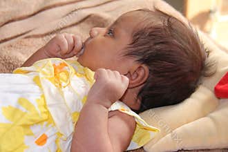 New born asian baby girl thinking
