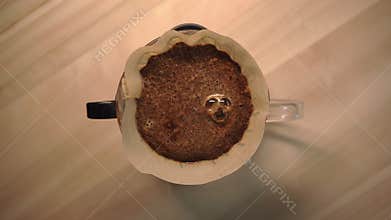 Making coffee with pour over method in the morning