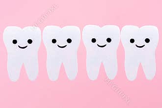 A row of white teeth with cartoon smiling faces, carved out of felt. Pink background. Copy space. The concept of
