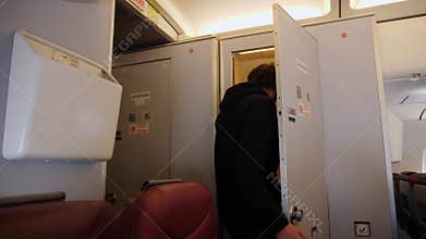 man in a black hoodie with a beard comes out