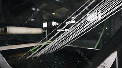 Extrusion production of plastic compounds. The strands are cooled before pelletizing.