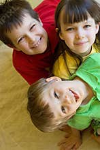 Three kids clowning at home