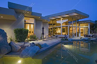 House With Pool In Backyard At Dusk