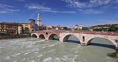 Ponte Pietra roman arch bridge crossing Adige River in Verona town, Italy, Europe