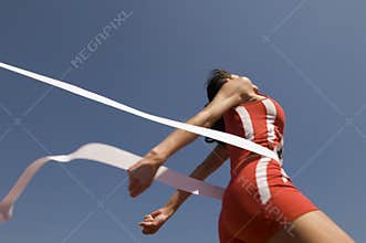 Female Athlete Crossing Finish Line Against Blue Sky