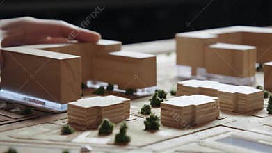Hands of Professional Man Constructing Architecture Model of Urban Town Building