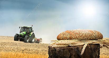 Bread and wheat cereal crops.Traktor on the background