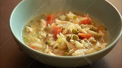 Chicken Soup with Lemon and Orzo CloseUp in Blue Bowl