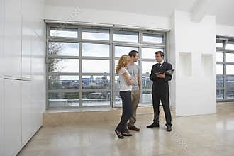 Real Estate Agent Showing Couple New Apartment