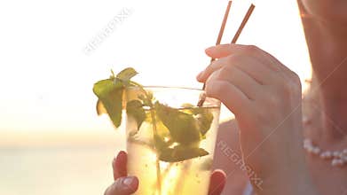 Woman enjoying a mojito cocktail