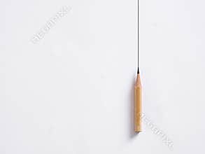Pencil draws a vertical line on white background. Drawing borders. Stability or stagnancy in business