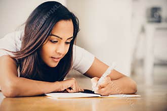 Happy Indian woman student education writing studying