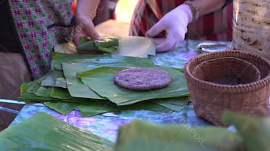 Grilling sticky rice with sesame sesame local Shan Tai yai food Chiangmai Thailand Southeast Asia banana leaf package