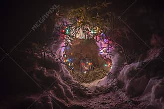 A decorated Christmas nook in the snow at night
