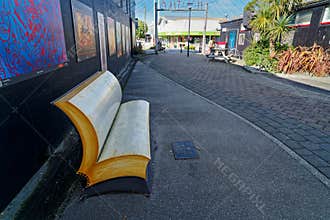 Destination scenics street art. A park bench styled like an open book