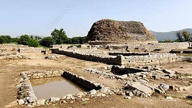 Sacred pond in front of Dharmarajika Stupa with historic ruins