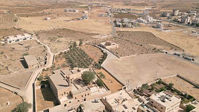 Drone aerial view of Mor Ahinsoya Monastery with nearby Meryem Ana Church near Midyat in Mardin Province, historic Syriac Orthodox