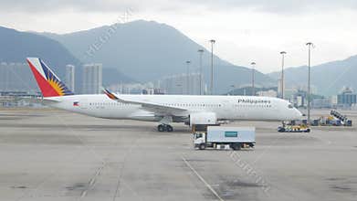 airside view in HKG Hongkong Airport while ground service staffs doing ground service operation push back Philippines airline